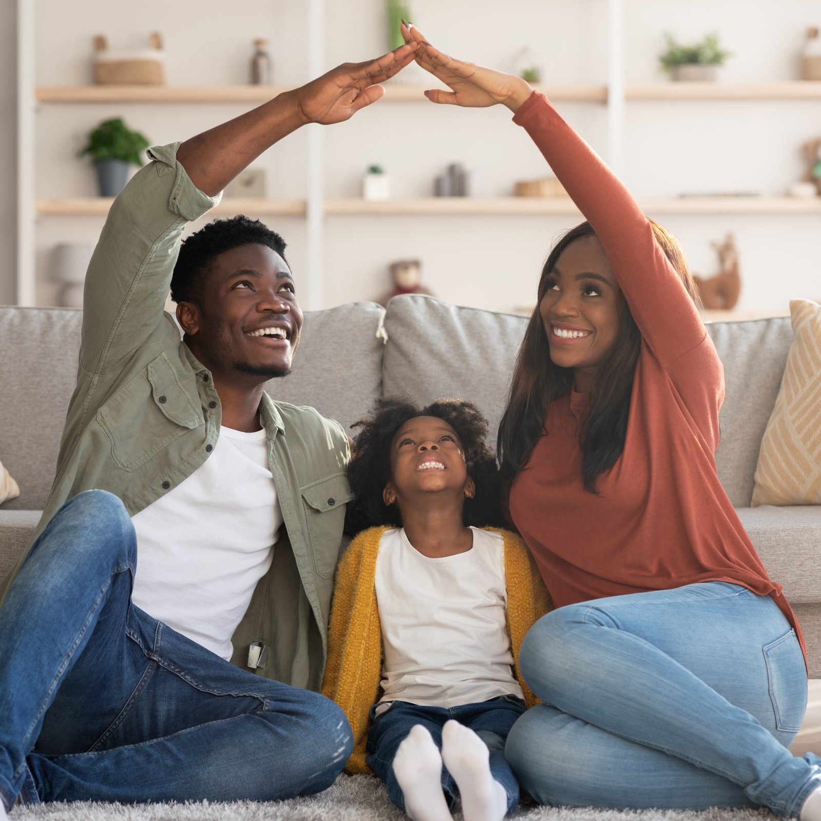 A couple comparing mortgage rates on their phones in a new home